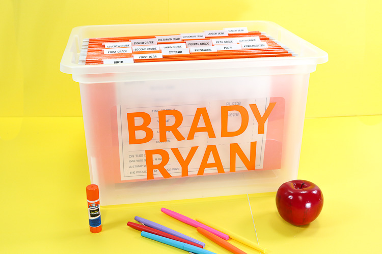 School Memory Bin with Name on outisde and a hanging folder for each year from birth through senior year. Printables on front act as a timeline and folders hold keepsakes
