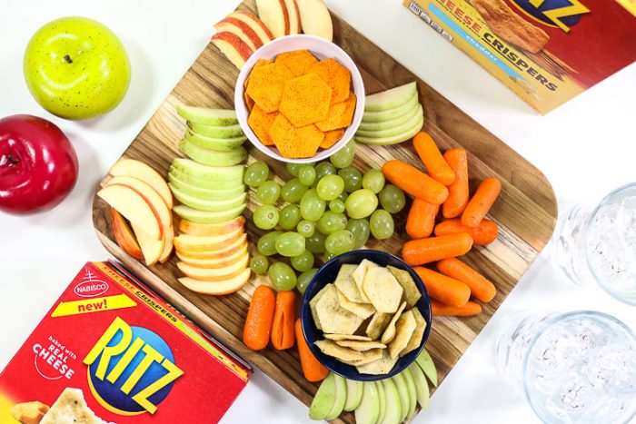 Overhead shot of board filled with fruit, veggies and Ritz Cheese Crispers