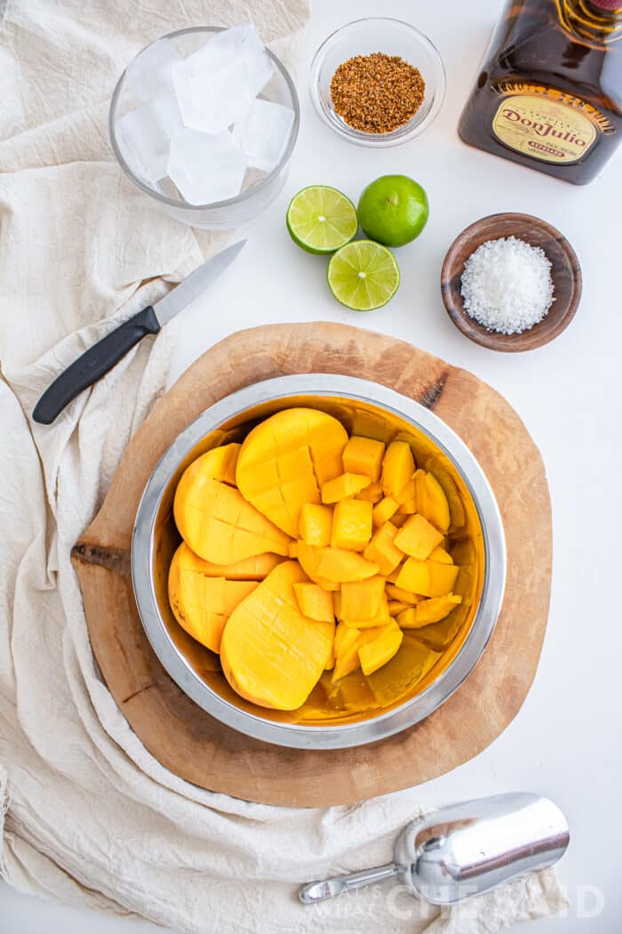 Fresh mangos being cut and cubed in a prep bowl