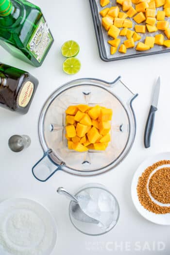 Frozen mango cubes inside a blender