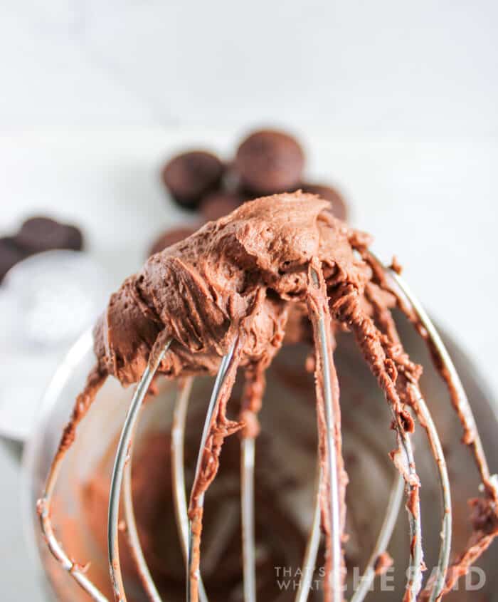 homemade chocolate buttercream frosting on a mixer whisk attachment